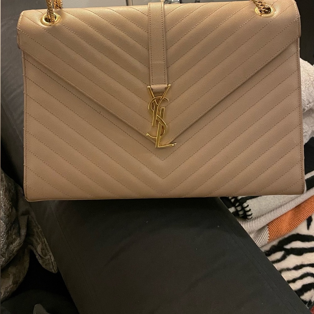 Used authentic YSL shoulder bag in beige with  gold chain in good condition.